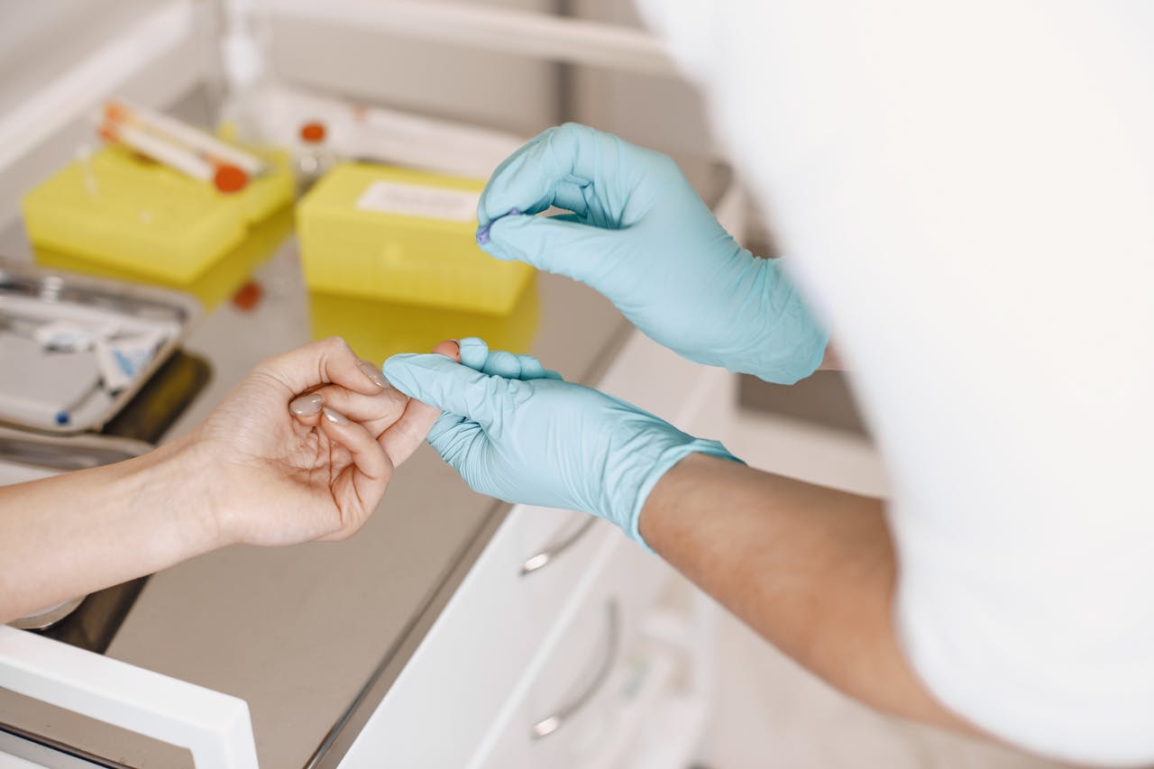 Nurse Taking a Blood Sample from a Finger